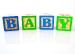 BABY spelled with wooden blocks
